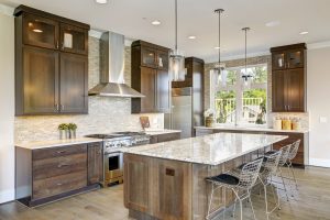 A beautiful modern kitchen with wood cabinetry and flooring